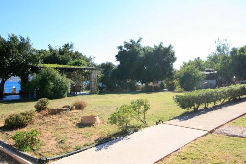 a park with a field with trees and a sidewalk at Seaside, relaxing family house with playground! Villa Lavrys 4 in Marathi