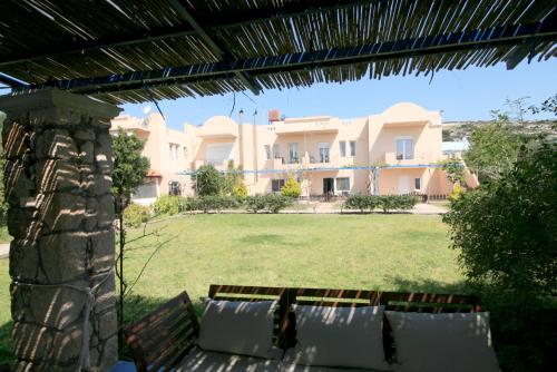 a view of a large house from a yard at Seaside, relaxing family house with playground! Villa Lavrys 4 in Marathi
