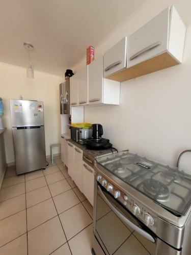 a kitchen with a stove and a refrigerator at Atacama Valley 10 in Copiapó