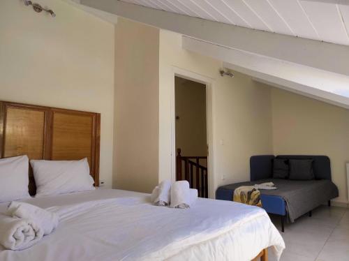 a bedroom with two beds with towels on them at THREE GRACES Apartments ZAKYNTHOS TOWN in Zakynthos Town