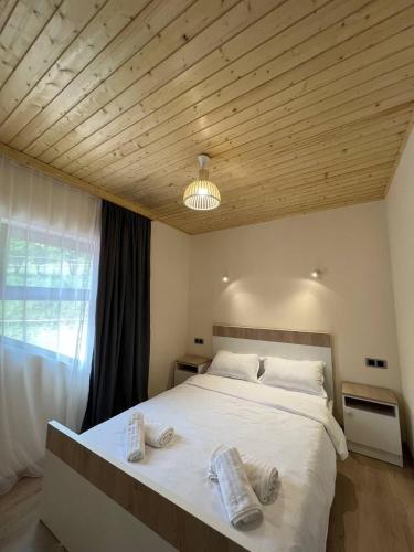 a bedroom with a large bed with towels on it at Dili guest house in Dilijan
