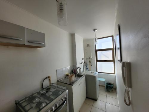 a kitchen with a sink and a stove top oven at Atacama Valley 3 in Copiapó