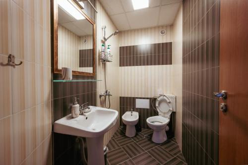 a bathroom with a sink and a toilet at Luxury Art 4 Apartment in Blagoevgrad