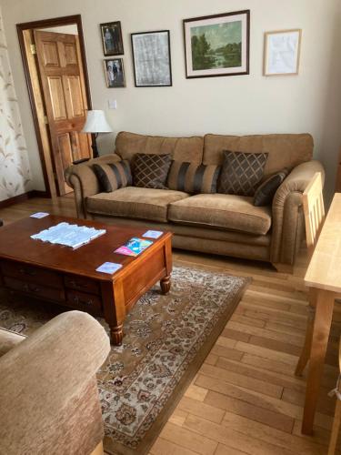 a living room with a couch and a coffee table at Deeleview apartment in Lifford