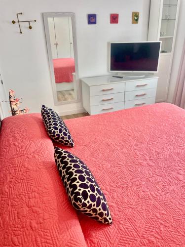 a bedroom with a bed with two pillows on it at In Love Zamora in Zamora