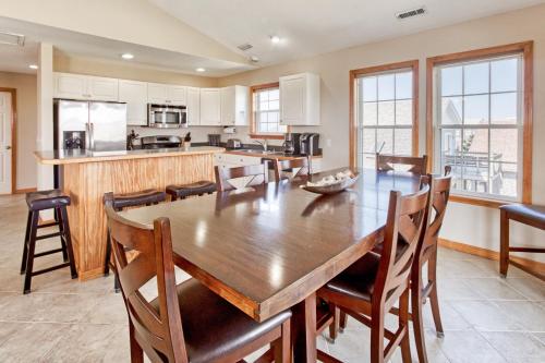 a large kitchen with a wooden table and chairs at Deja Blue 917 in Frisco