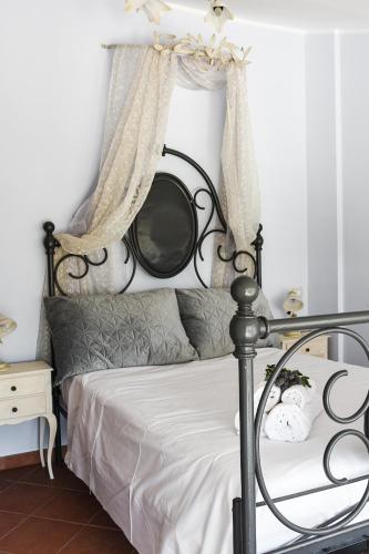 a bedroom with a bed with a black frame at Tenuta delle Acque in Acquasparta