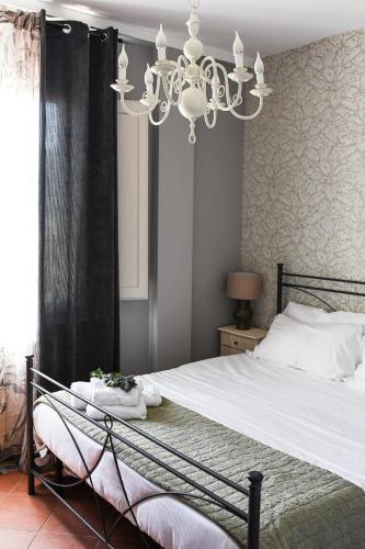 a bedroom with a large bed with a chandelier at Tenuta delle Acque in Acquasparta