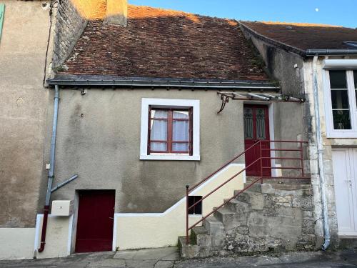 a house with a staircase leading up to a window at STUDIO DANS LA BRENNE ! in Thenay
