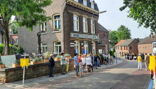 a crowd of people standing outside of a building at Auberge A gen Kirk B&B in Vijlen