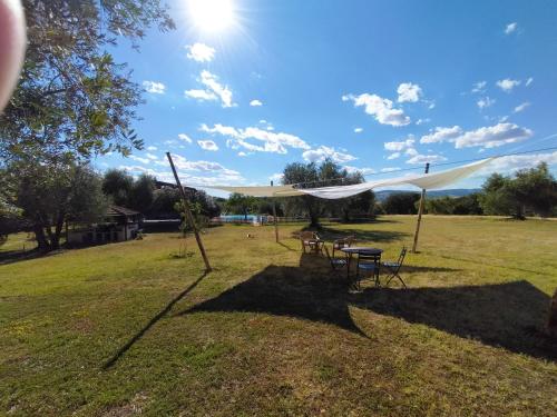a tent in a field with a table and chairs at Agriturismo Bio Pian Dei Casali in Saturnia