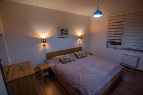 a bedroom with a bed and a window and lights at Alen Apartment Old town - Free Parking in Sarajevo