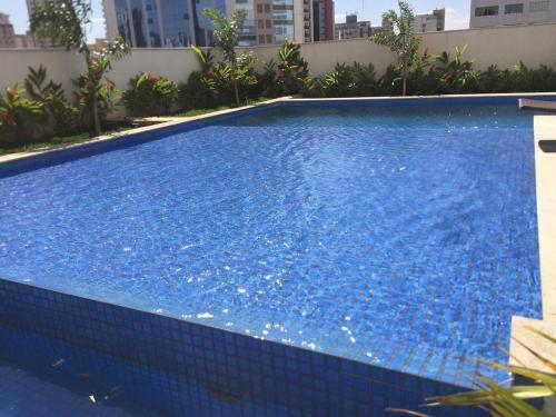 a large swimming pool with blue tiles on the side of a building at Lounge 22 Praça do Sol Tamandaré Shopping Bouganville Jotas Bartolomeu Cartório Artiaga Hospital do Coração Annis Rassi Íbis Holliday Rua 9 Feira da Lua Bodytech Marista Madalena Bahrem Nord23 Pão de Açúcar Alameda das Rosas Zoológico in Goiânia