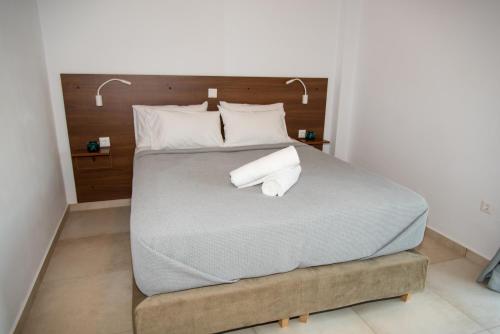 a bedroom with a large bed with two white pillows at HELIADES SUITES in Panteli