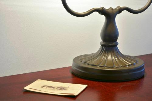 a lamp sitting on a table next to a card at History House in Corfu Town