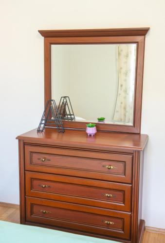 a dresser with a mirror on top of it at Villa ATL in Blagaj