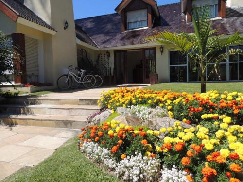 a flower garden in front of a house at Petit Chateau Hotel Boutique in Punta del Este