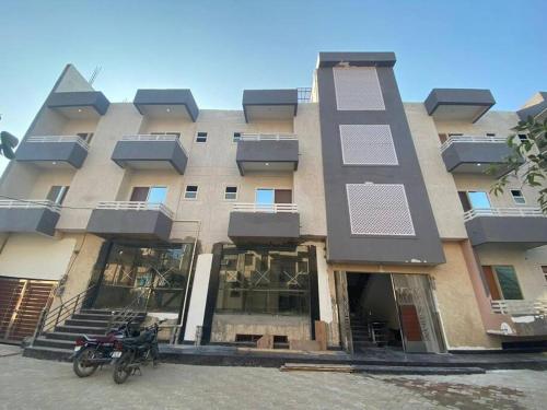 a building with two motorcycles parked in front of it at ISKCON Hare Krishna Homestay in Vrindāvan