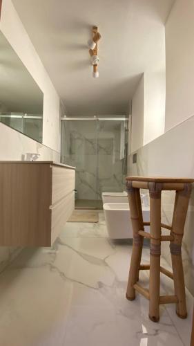 a bathroom with a shower and a wooden table at Greek Temple in Agrigento