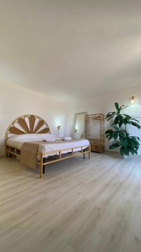 a bedroom with a large bed and a potted plant at Greek Temple in Agrigento