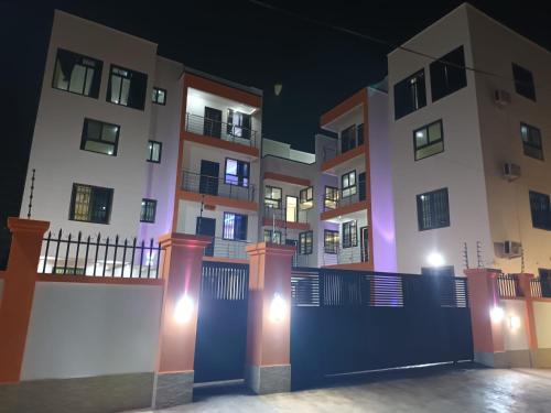 a rendering of a building at night at Impeccable 1-Bedroom Furnished Apartment in Accra in Accra