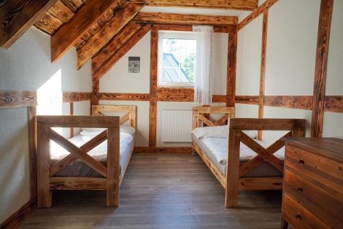 a bedroom with two beds and a window at Domek na Kaszubach przy lesie i wodzie, Załakowo, Na Gwizdówce, Różany Domek II Kaszubska Wenecja in Pałubice