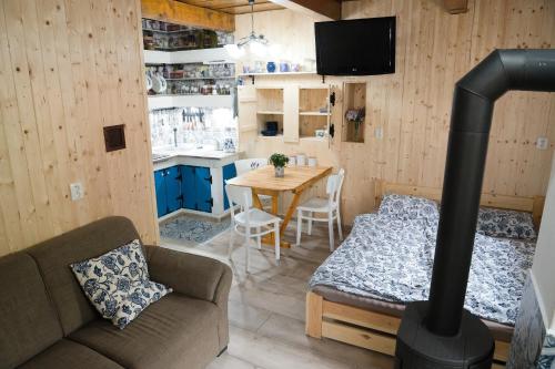 a living room with a couch and a table with a stove at Apartmán Levandule 