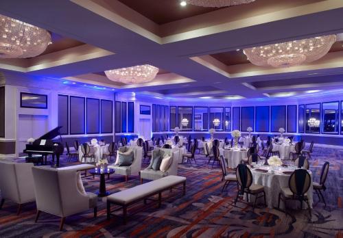 a ballroom with tables and chairs and a grand piano at Omni Richmond Hotel in Richmond