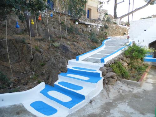a set of stairs painted blue and white at Villa Kotetsi - Rooms To Let - Volissos - Chios in Volissos