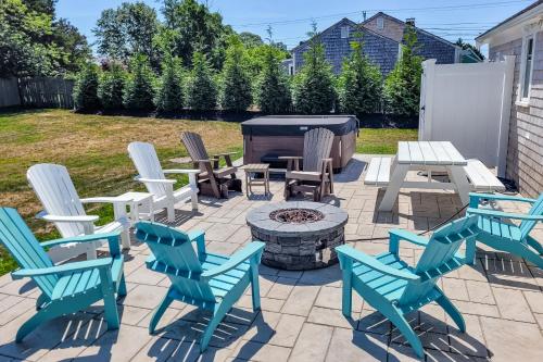 a patio with chairs and a fire pit with a grill at Cape Cod Playhouse in Yarmouth