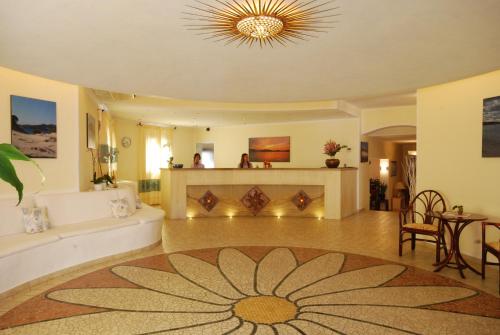 a large living room with a large flower on the floor at Hotel Mon Repos in Baja Sardinia