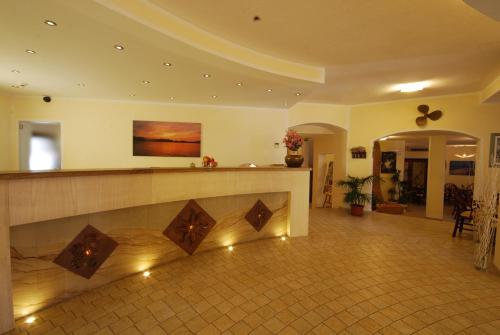 a lobby with a reception counter in a building at Hotel Mon Repos in Baja Sardinia