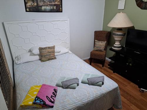 a bedroom with a bed with two pillows on it at Baynefamilyflorida. in Fort Lauderdale