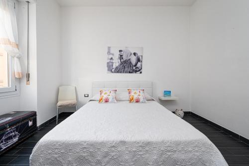 a bedroom with a large white bed with two pillows at Affittacamere Sa Pardula in Cagliari