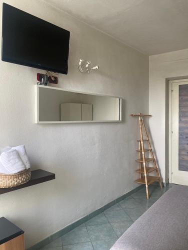 a room with a flat screen tv on a wall at Black Market Hotel in Ischia