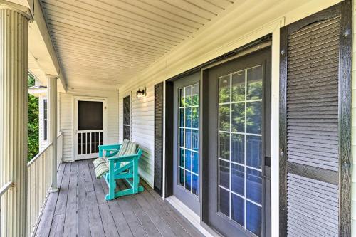 a porch with a blue chair on a house at Spacious White Rivers Jewel Fishing Haven! in Flippin