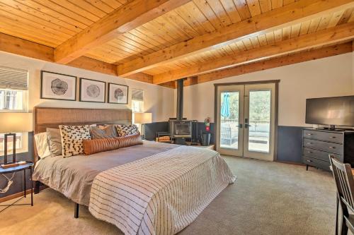 a bedroom with a bed and a television in it at Pet-Friendly Cottage, Walk From Big Bear Village! in Big Bear Lake