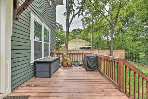 a wooden deck with a bench on a house at Modern Charlotte Home about 4 Mi to Downtown! in Charlotte