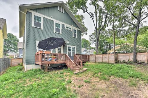 a house with a deck with an umbrella at Modern Charlotte Home about 4 Mi to Downtown! in Charlotte