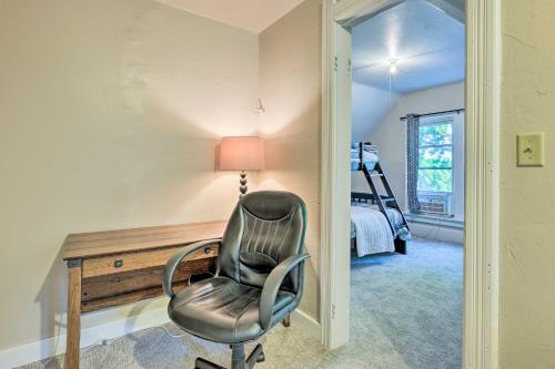 a chair in a room with a desk and a bed at Milwaukee Home Less Than Half Mi to Lake Michigan! in Milwaukee