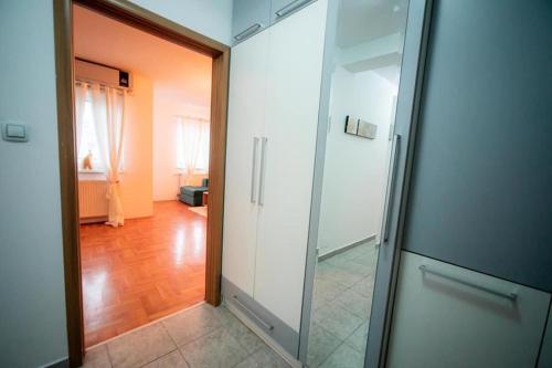 un couloir avec une porte en verre menant à une chambre dans l'établissement Lux stan na dan Pozarevac, à Požarevac