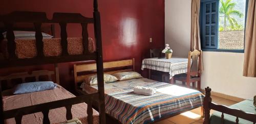a bedroom with two bunk beds in a room at Hotel Nevada Ubatuba in Ubatuba