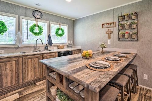 a kitchen with a large wooden table and a sink at Updated Tuskahoma Cabin with Fire Pit and Deck! in Tuskahoma