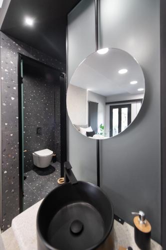 a bathroom with a black sink and a mirror at COCO SUITES in Vasiliki