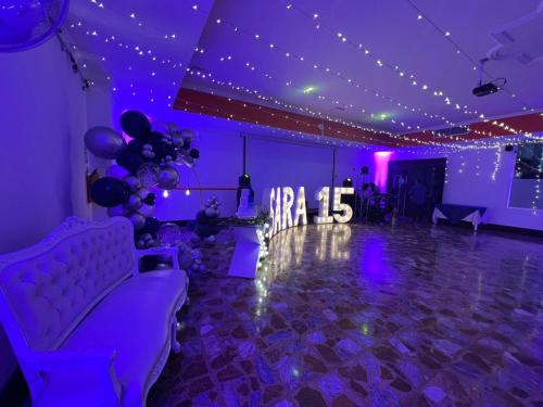 a purple room with a dance floor with purple lights at Hotel del Llano in Villavicencio
