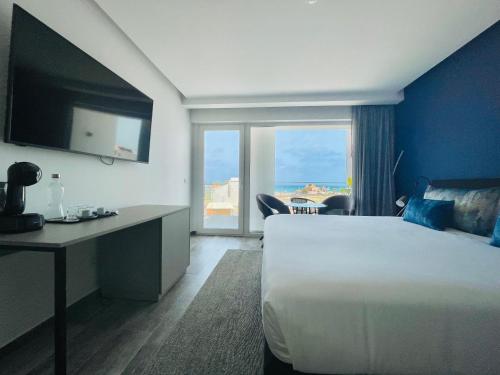 a hotel room with a large bed and a large window at DESIGN SUITES Boutique Hotel - Adults Only in Santa Maria