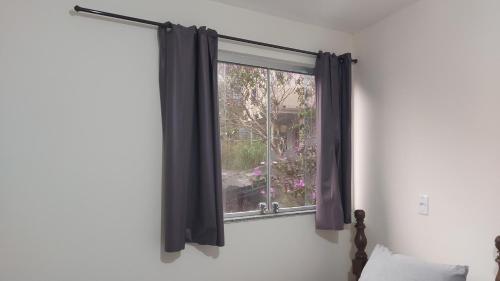 a window with black curtains in a room at Star Hotel 206 Diferente in Juiz de Fora