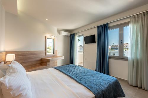 a bedroom with a bed and a large window at Orama apartment in Nea Kydonia