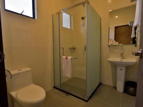y baño con ducha, aseo y lavamanos. en Asiana Hotel, en Kota Kinabalu