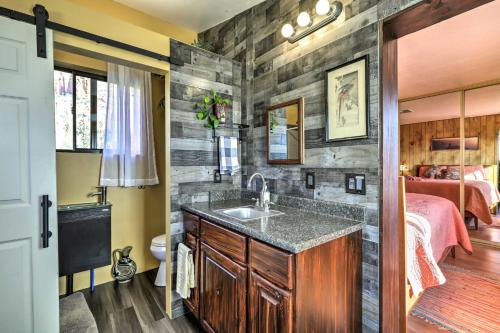 a bathroom with a sink and a bedroom at Sedona Studio at Thunder Mountain in Sedona